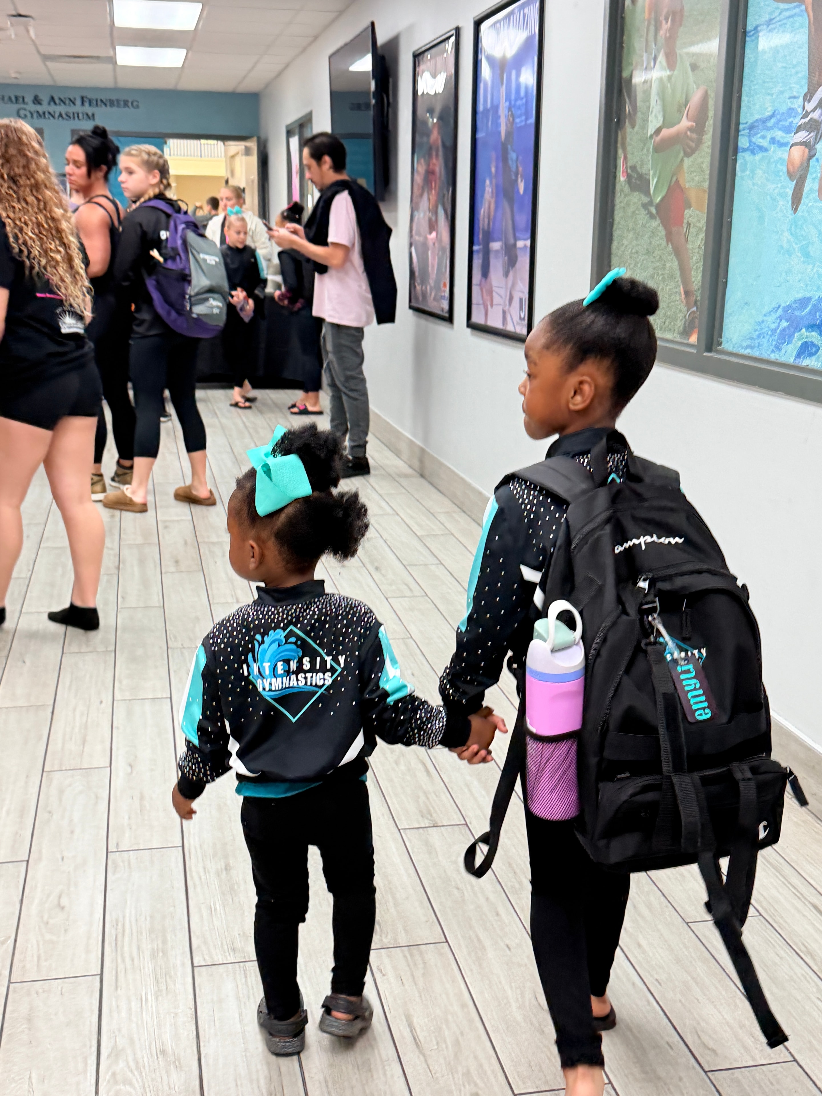 Intensity Gymnastics athletes in team gear at a competition venue