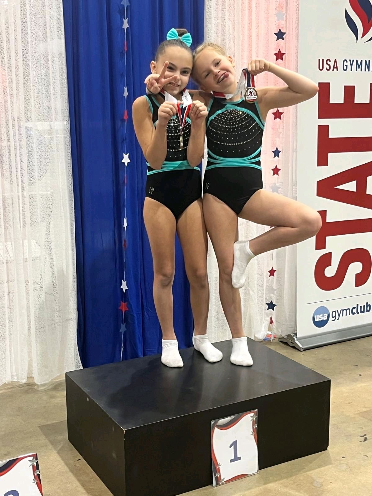 Young Intensity Gymnastics athletes on the podium at USA Gymnastics State competition